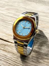 Patek Philippe style two-tone watch with sky blue dial and stainless steel + gold bracelet – luxury design
